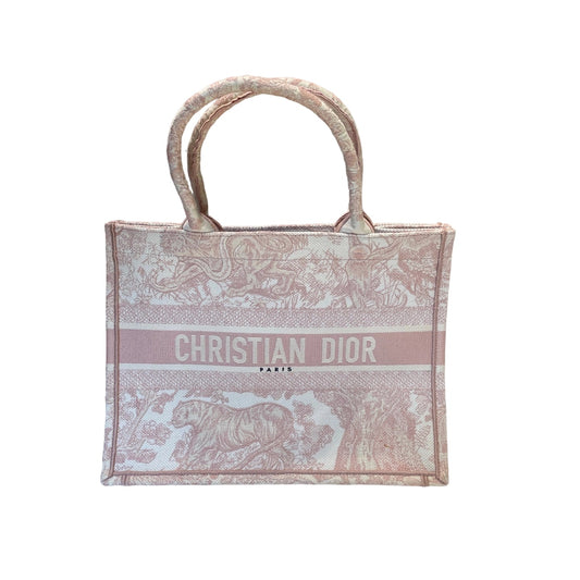 Christian Dior Medium Book Tote in pink and white Toile de Jouy embroidery. Features tiger and tree motifs with Christian Dior Paris signature logo strip on the front.