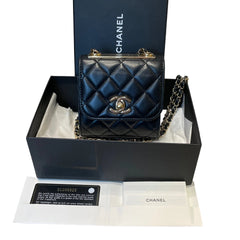Authentic Chanel Mini Trendy CC square bag in black quilted lambskin featuring top gold-tone metal logo plate and series 31 card