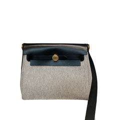 Front view of an authentic Hermès Herbag Messenger Mini in Panda color blocking with black leather flap and slate gray canvas body