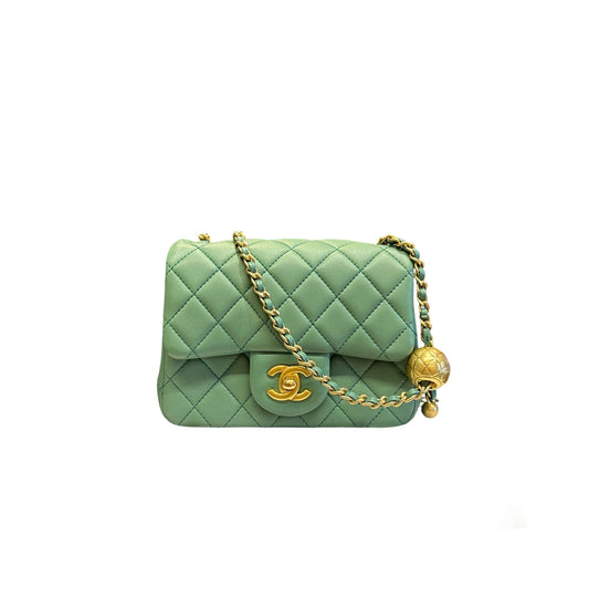 Authentic Chanel Mini Square Flap bag in sage green lambskin featuring the iconic golden ball adjustable chain and CC turn-lock