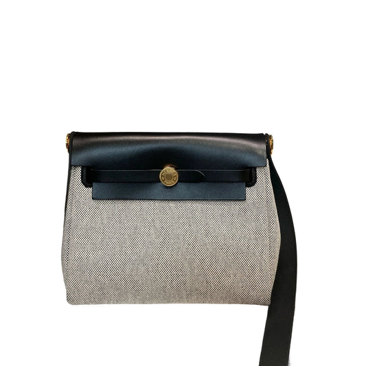 Front view of an authentic Hermès Herbag Messenger Mini in Panda color blocking with black leather flap and slate gray canvas body